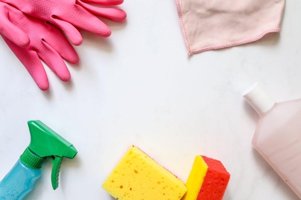 A flat lay of assorted cleaning supplies, perfect for housekeeping themes.